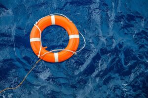 Orange buoy on dark blue water