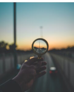 Looking at the end of a road though a magnifying glass at sunset