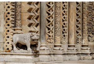 Sculpture of animal protecting an ornate ancient building