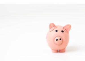 Cute pink piggie bank on white background